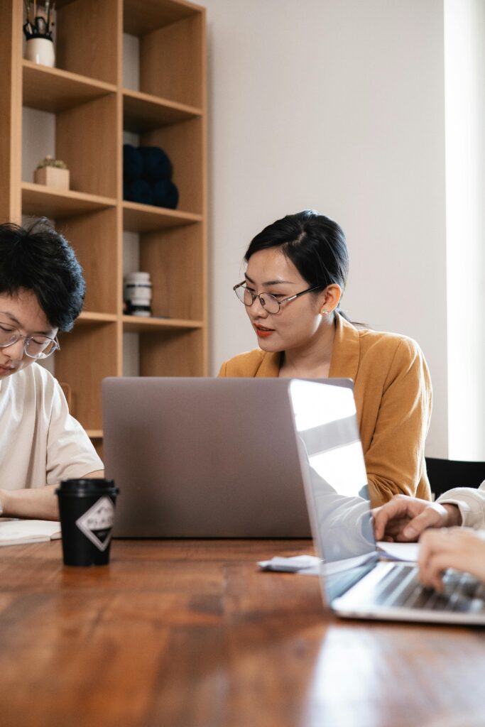 Focused team working together in a modern office with laptops, showcasing teamwork and collaboration